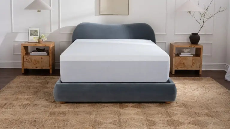 Waterproof, crinkle-free mattress protector on a neatly made bed.